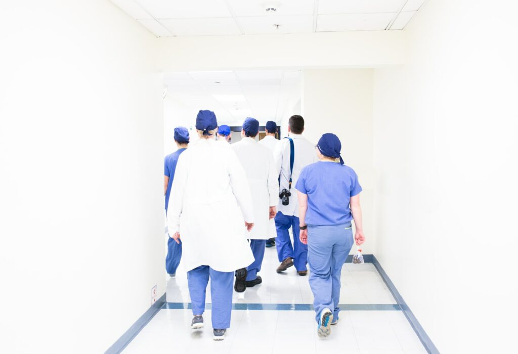 image of hospital staff walking down corridor wearing scrubs | North Memorial Health and Oracle