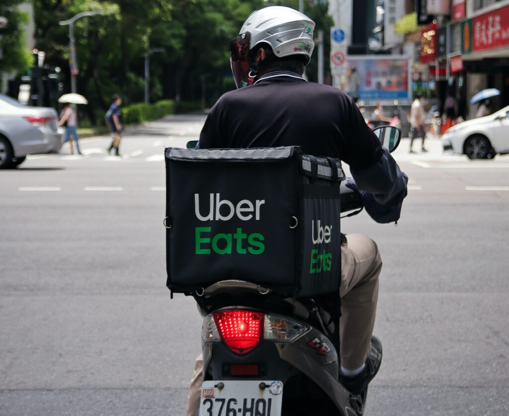 image of delivery driver on Moped | Uber and Google