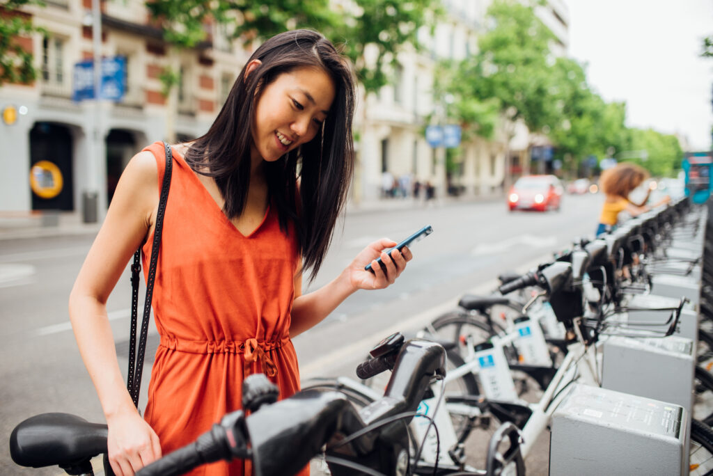 Woman looking at bikes on the street: sap subscription economy