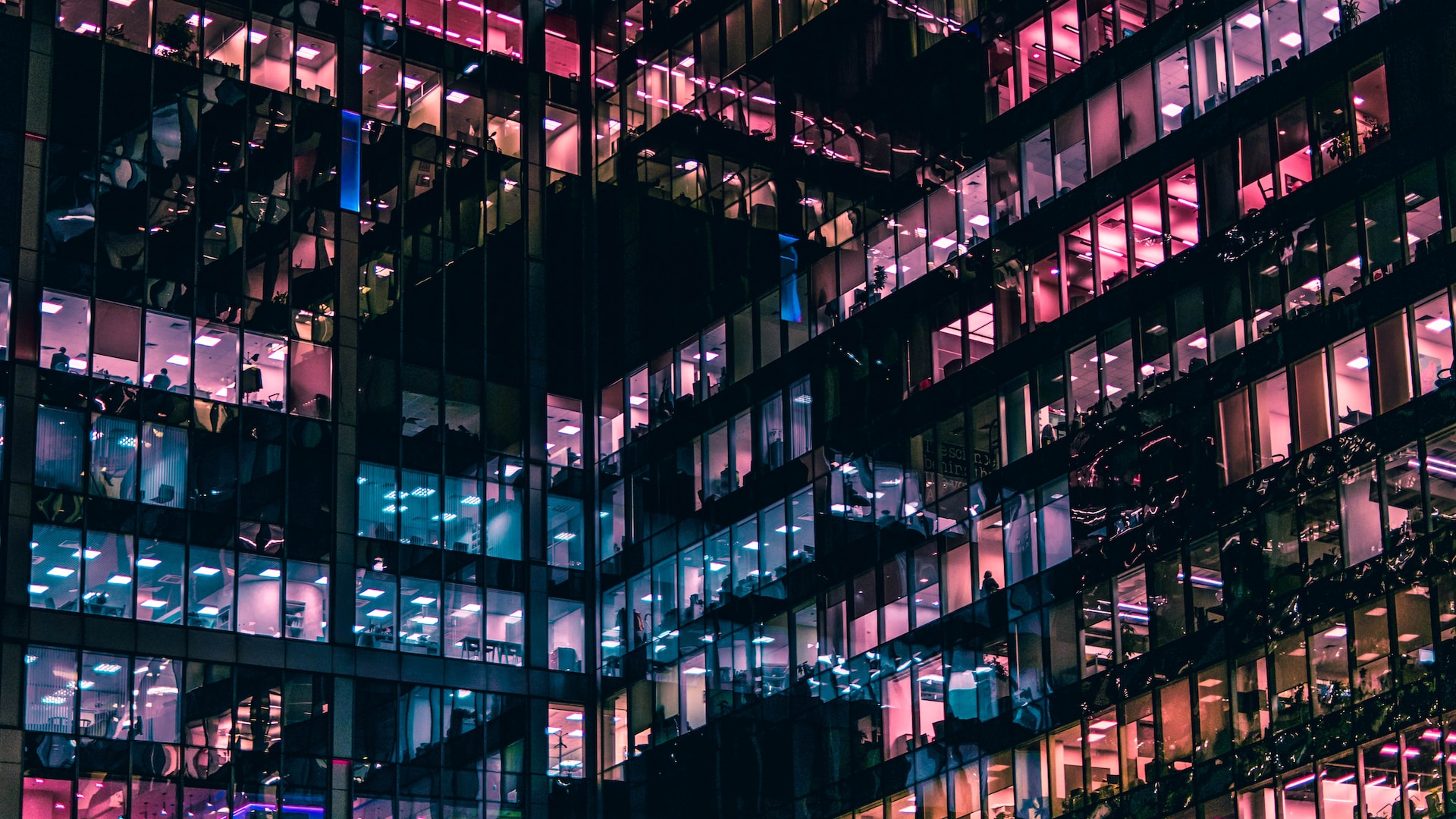 image of building with different lights, blue and pink, with some people in view | data-driven