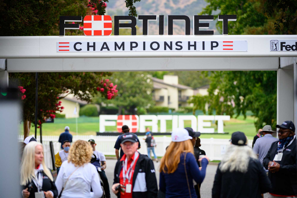 Fortinet Cup Championship banner with members standing under it.