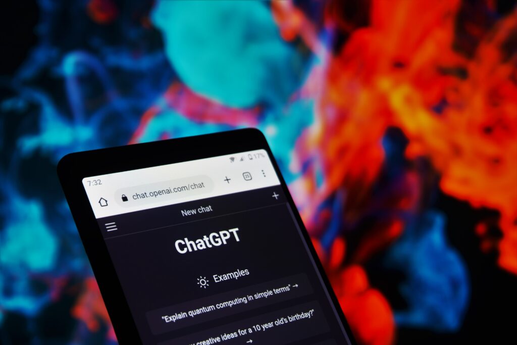 The ChatGPT page open on a smartphone in front of a colourful background