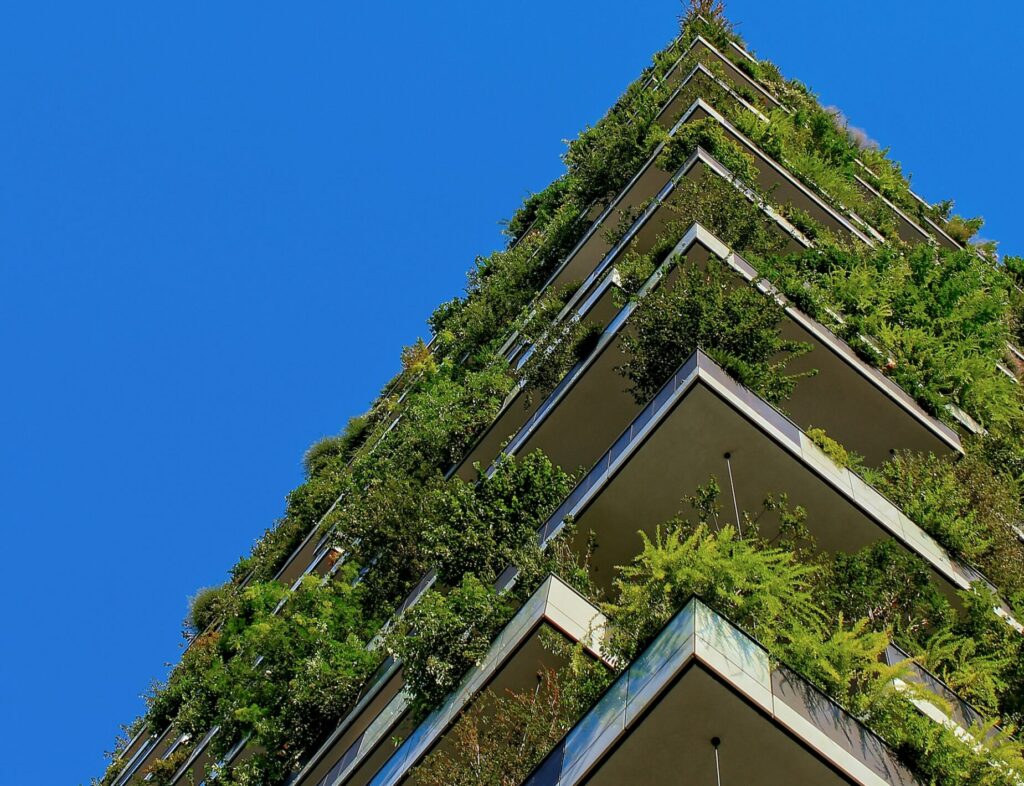 image of 'green housing' a block of flats with flourishing green plants | HCLTech and Schneider Electric