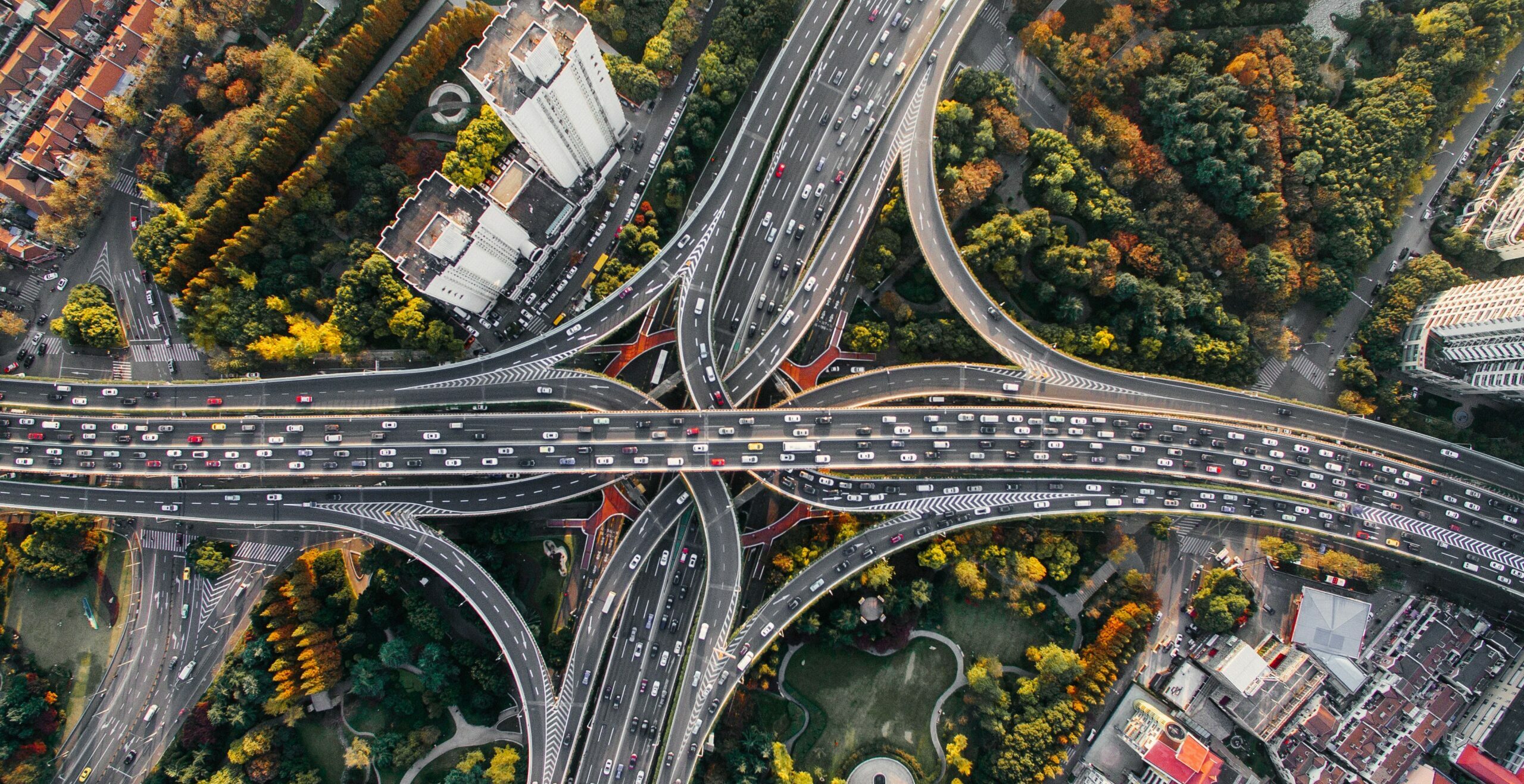 Top down view of a busy highway over a park in suburban China | Infor and P3