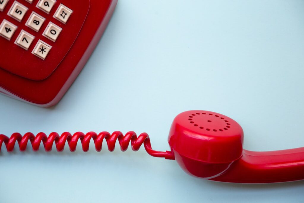 image of red telephone on blue background | IFS and Tele2