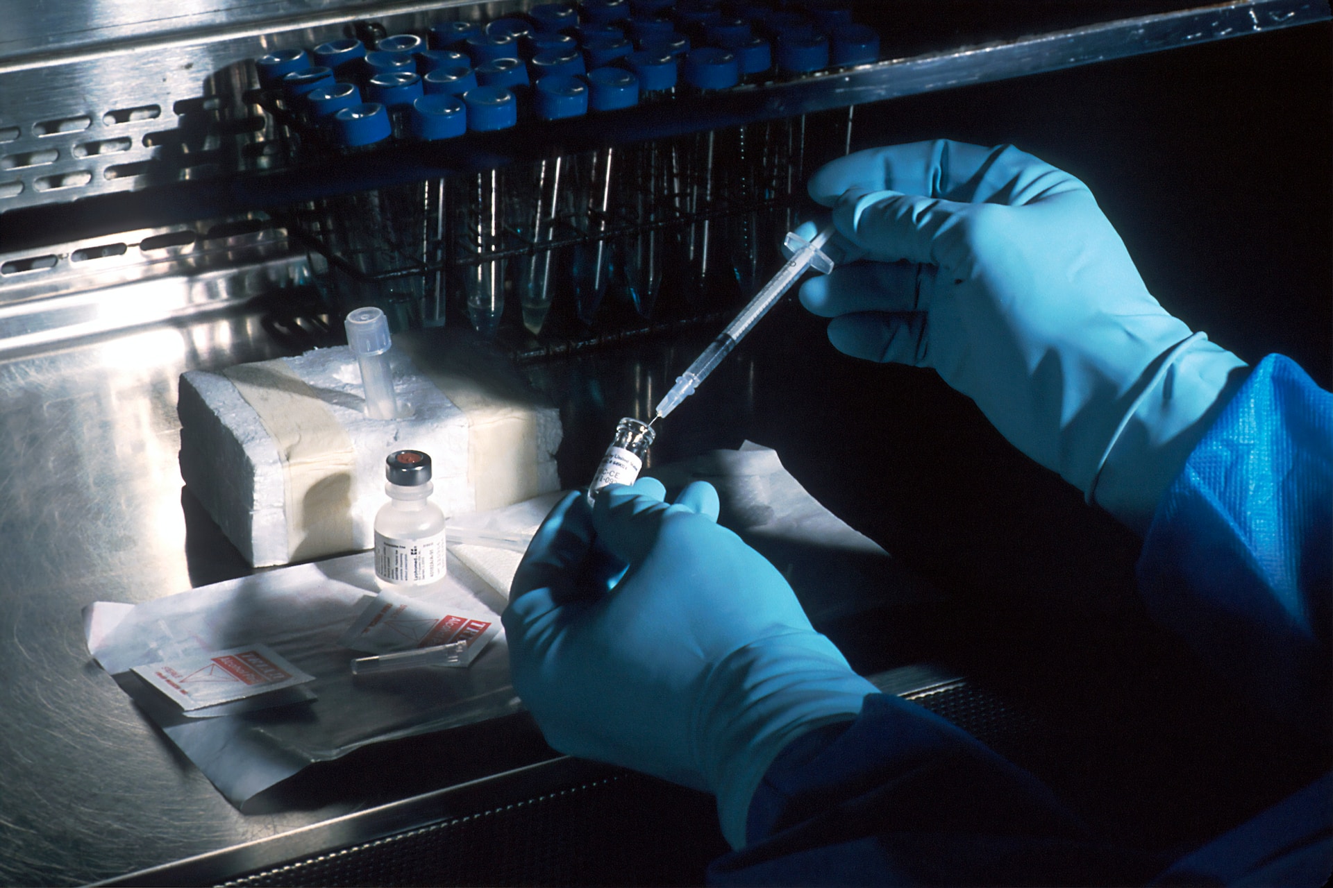 Hands of a scientist, under a sterile hood, preparing the carcinoembryonic antigen (CEA) vaccinia used to try to prevent cancer | Oracle and CancerX