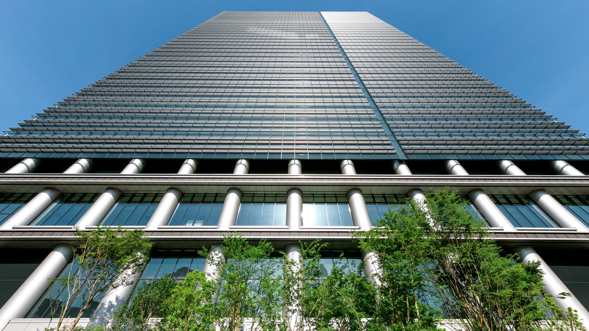 Sumitomo headquarters building with green plants.