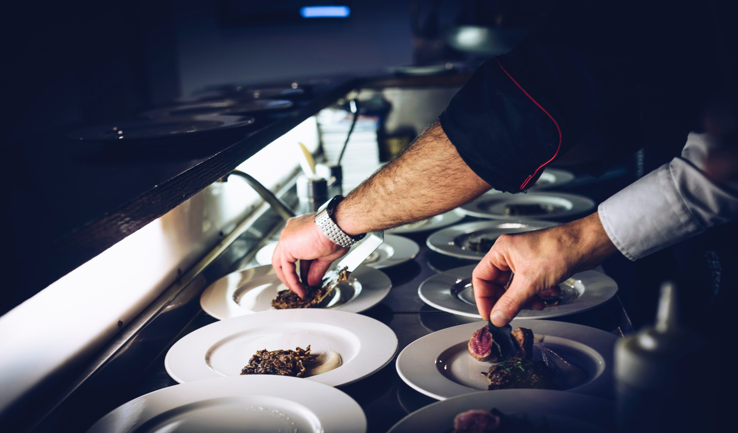 ERP implementation | An image of chefs' hands putting the final touches to Michelin-star meals