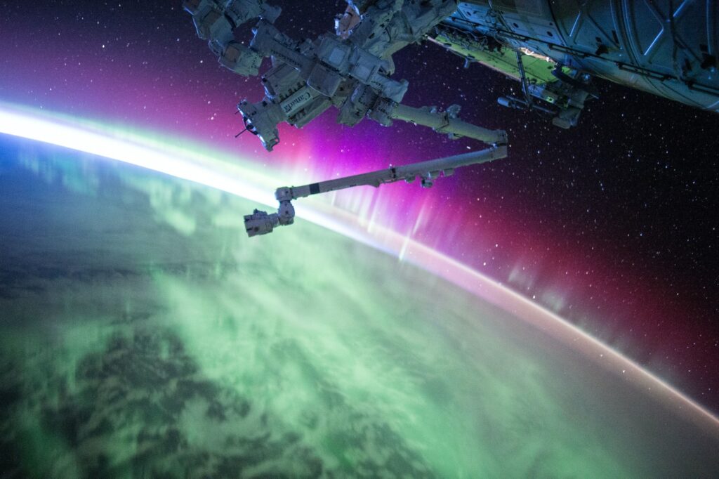 image of satellite over planet Earth with northern lights in the sky | IBM and Ubotica