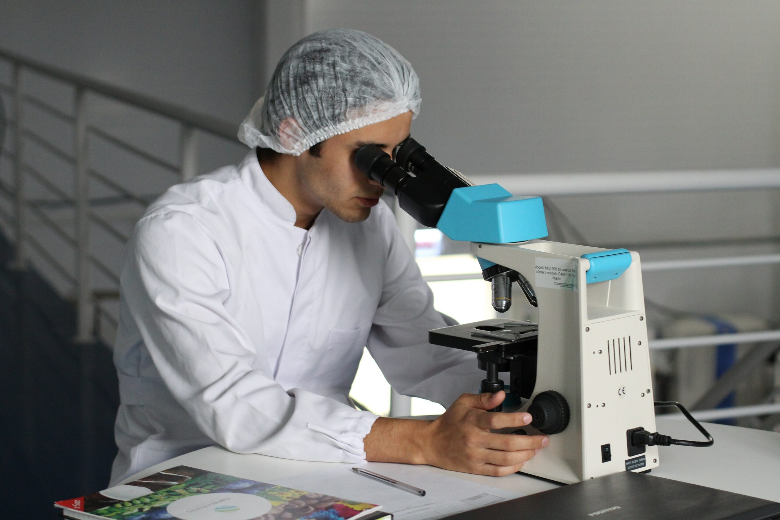 Healthcare professional gazing through microscope in a clinical setting | Google Cloud healthcare