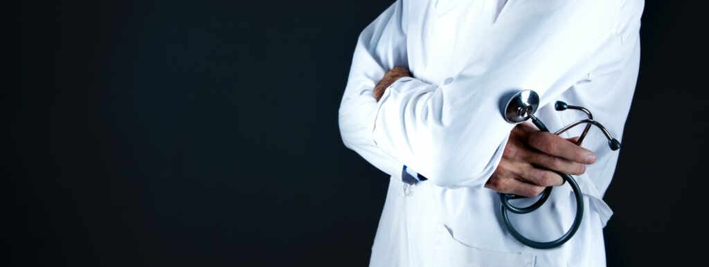 image of doctor in white coat holding a stethoscope | NHS