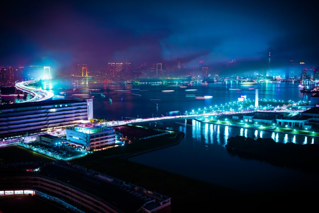 A timelapse photo of a port city with neon streaks representing movement | AI tools Unit4