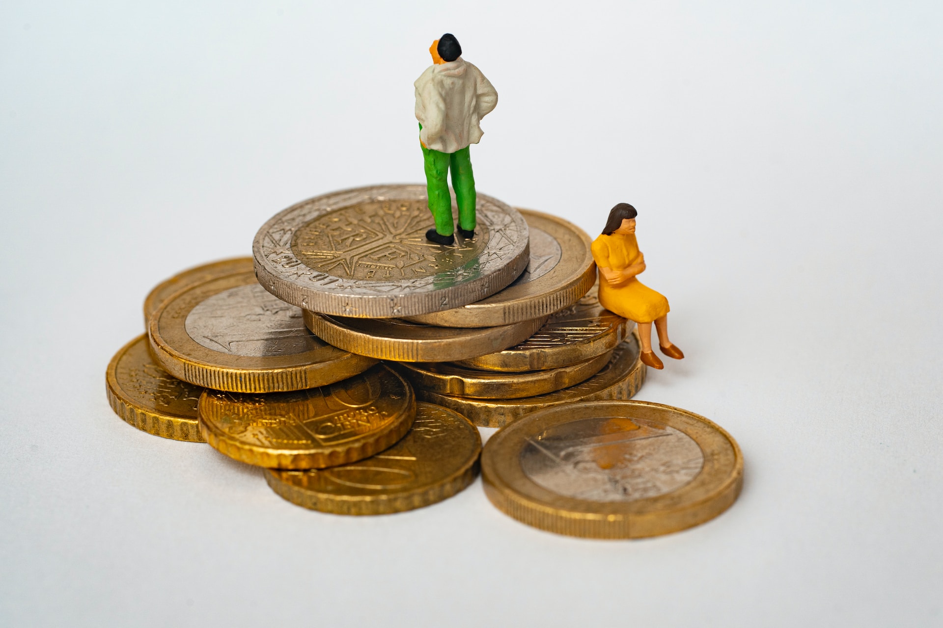 image of small figurines standing on a pile of coins | LSEG and Oracle
