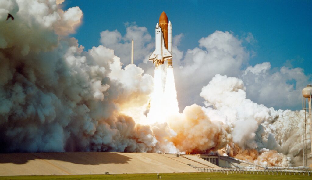 Rocket that's blasting into space from the launchpad with lots of smoke | cloud-based Infor