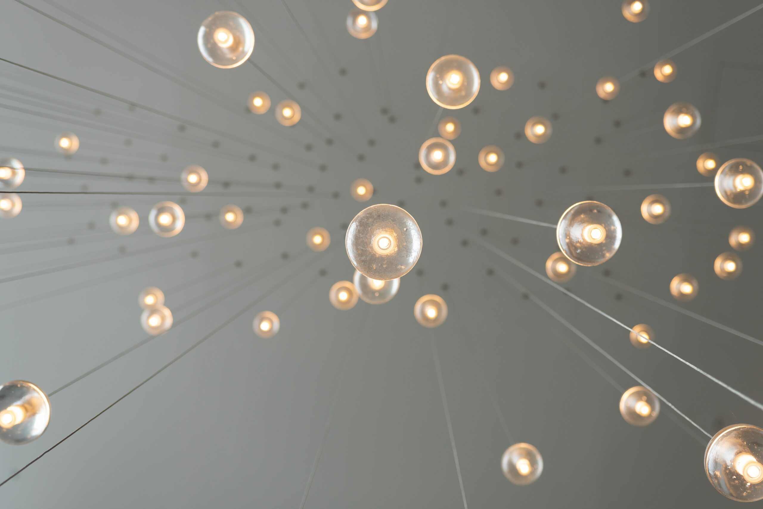 Lightbulbs hanging from the ceiling on barely-visible strings | UiPath clipboard AI