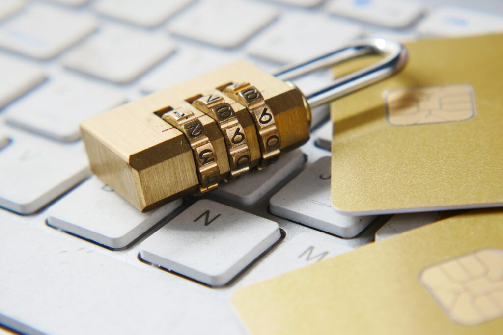 image of padlock and gold cards on laptop | Microsoft and Amazon