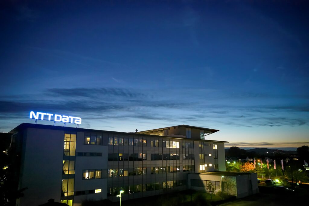 A wide angle view of an NTT DATA building, taken on an evening | NTT Sapphire