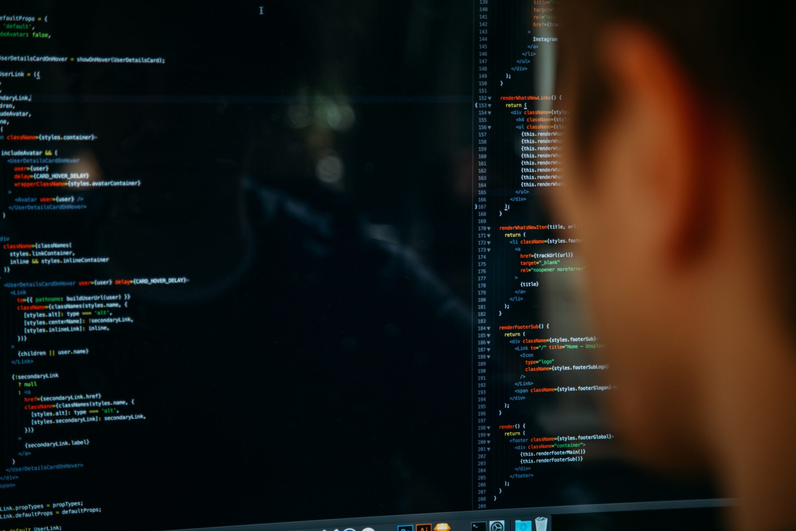 Close up of a screen of coding with a developer in the the forefront of the picture but isn't in focus | citizen development Nextworld