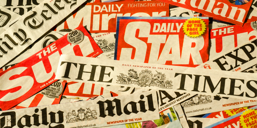a bunch of tabloid newspapers and magazine with red covers | ERP implementation