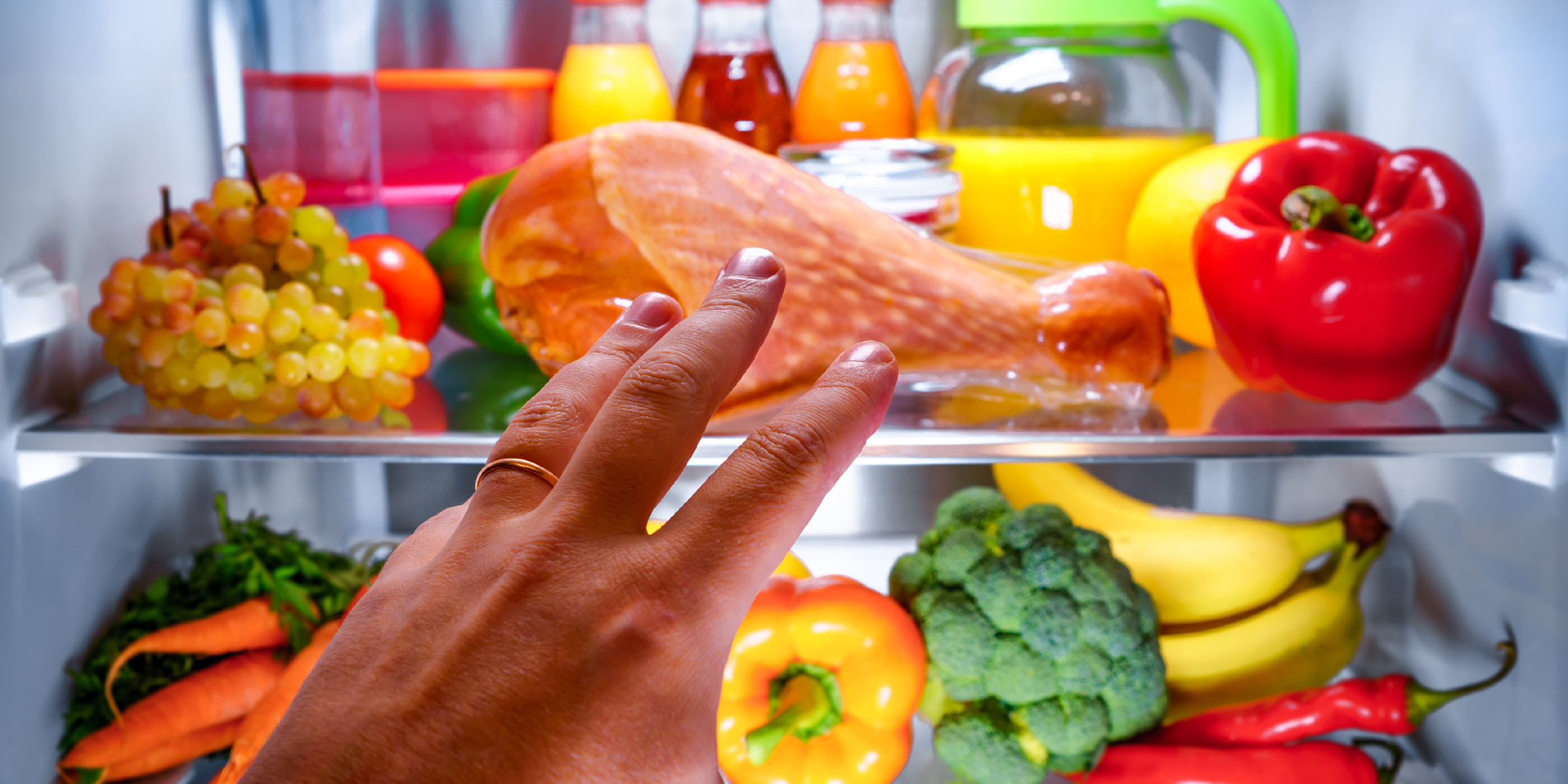 Image of a hand reaching into a fridge full of appealing looking food, in date. | LLM data