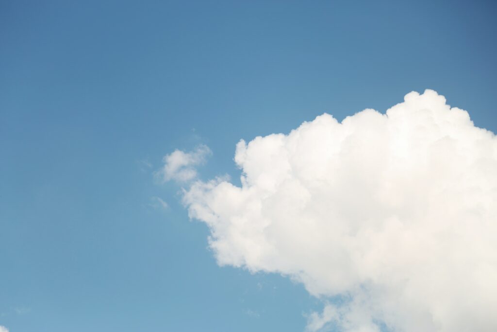 Open blue skies with a giant cloud creeping in from the right hand side | Cloud software Infor