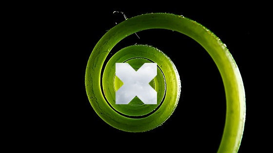 A swirling green spiral on a black background, with a white X superimposed over the centre of the spiral | Data sovereignty Nutanix