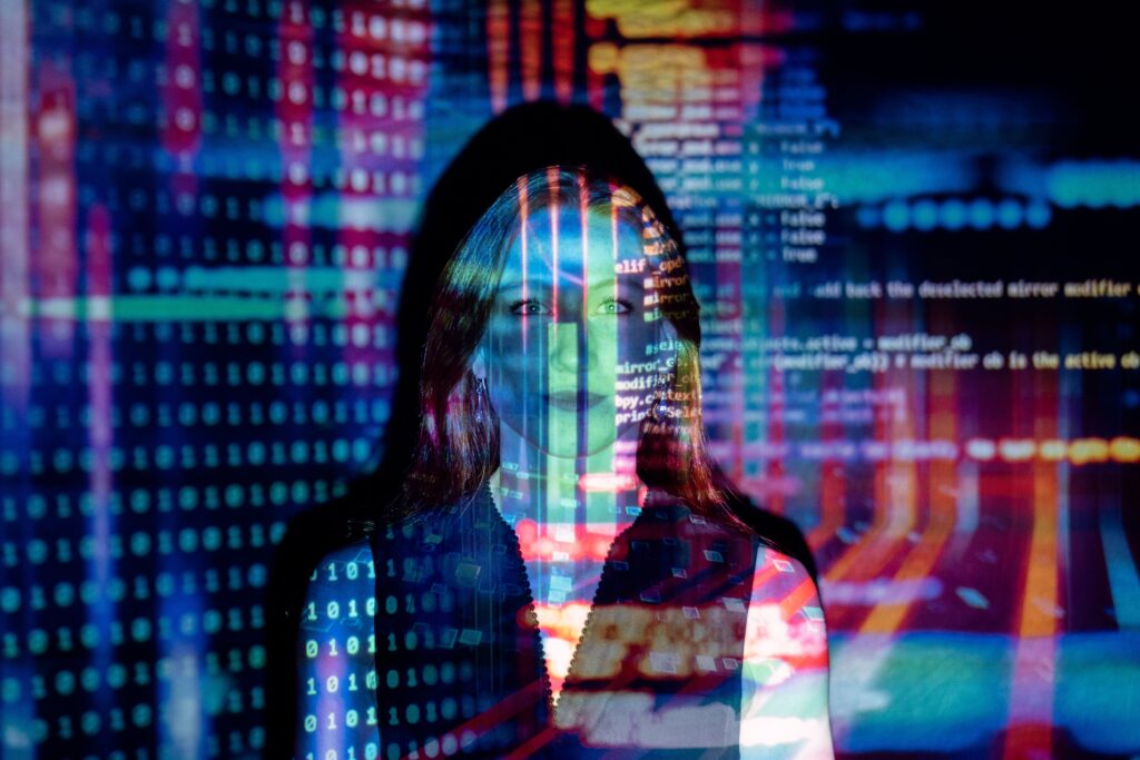 projected image of software code onto screen with woman engineering software