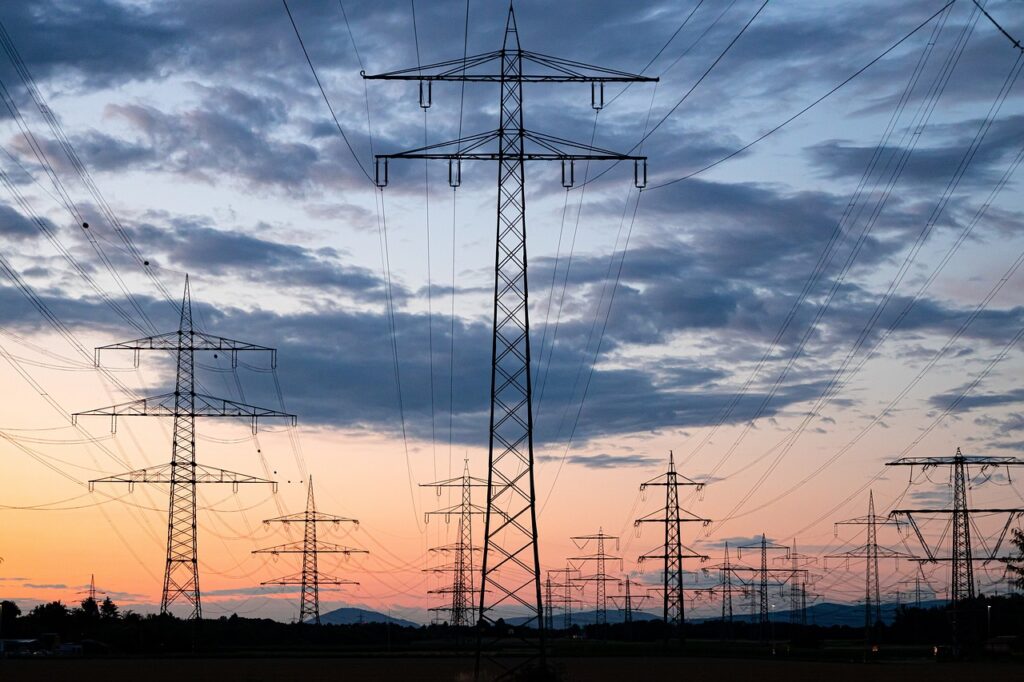 Electric power lines with a sunset in the sky | Salesforce innovations help scale clean energy programs