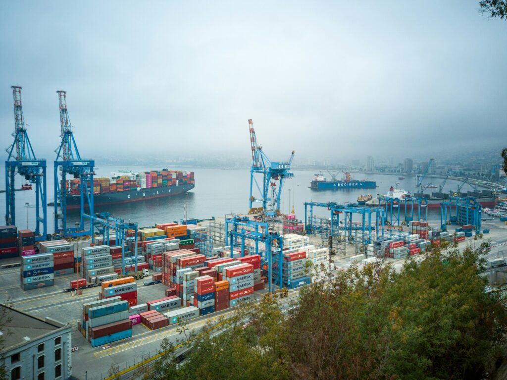 A view overlooking a harbour that contrains a large amount of shipping containers | Supply Chain Management Accelalpha