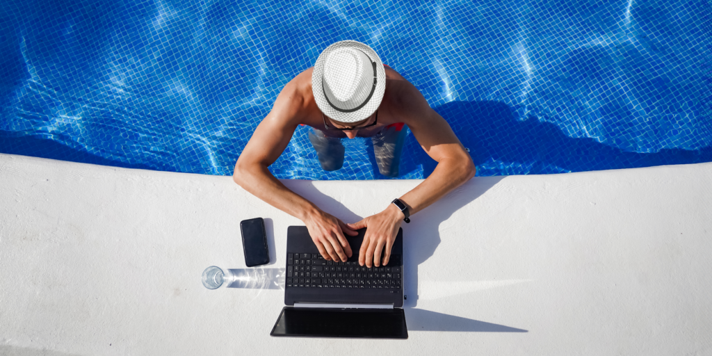 a person working on a laptop from a swimming pool | Workforce gone walkabout
