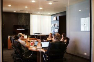 four people in a discussing inside a meeting room | Workday and Randstad collaborate for sustainable HCM