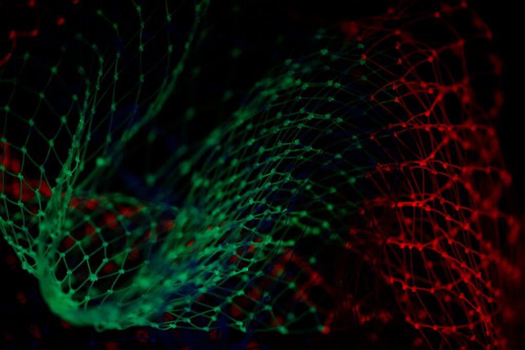 Abstract image of a green and red net entwined together across a dark background | More4apps digital transformation
