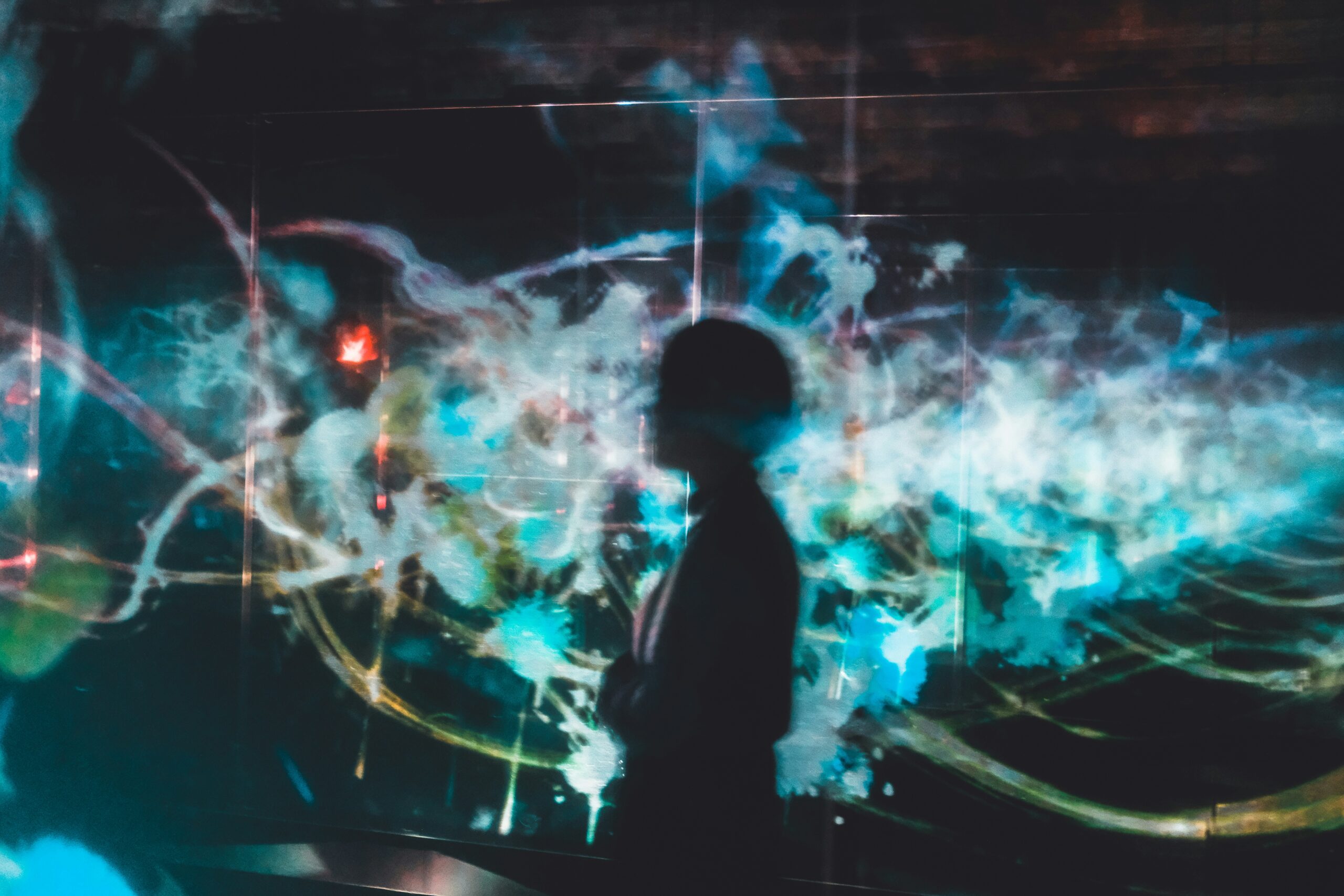 abstract image of a man in front of blue, white and yellow digital light; AI concept