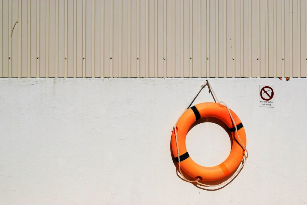 photo of an orange life buoy hanging on a wall | Oracle system support concept