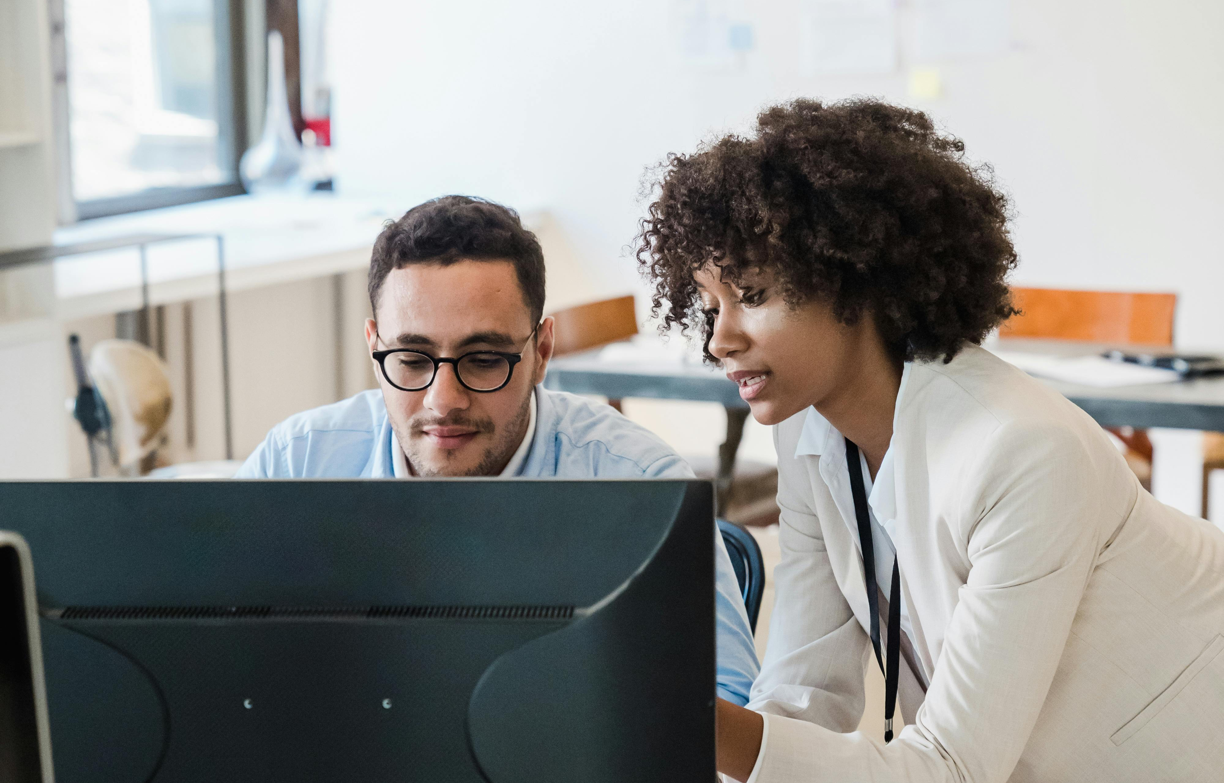 people in office around a computer