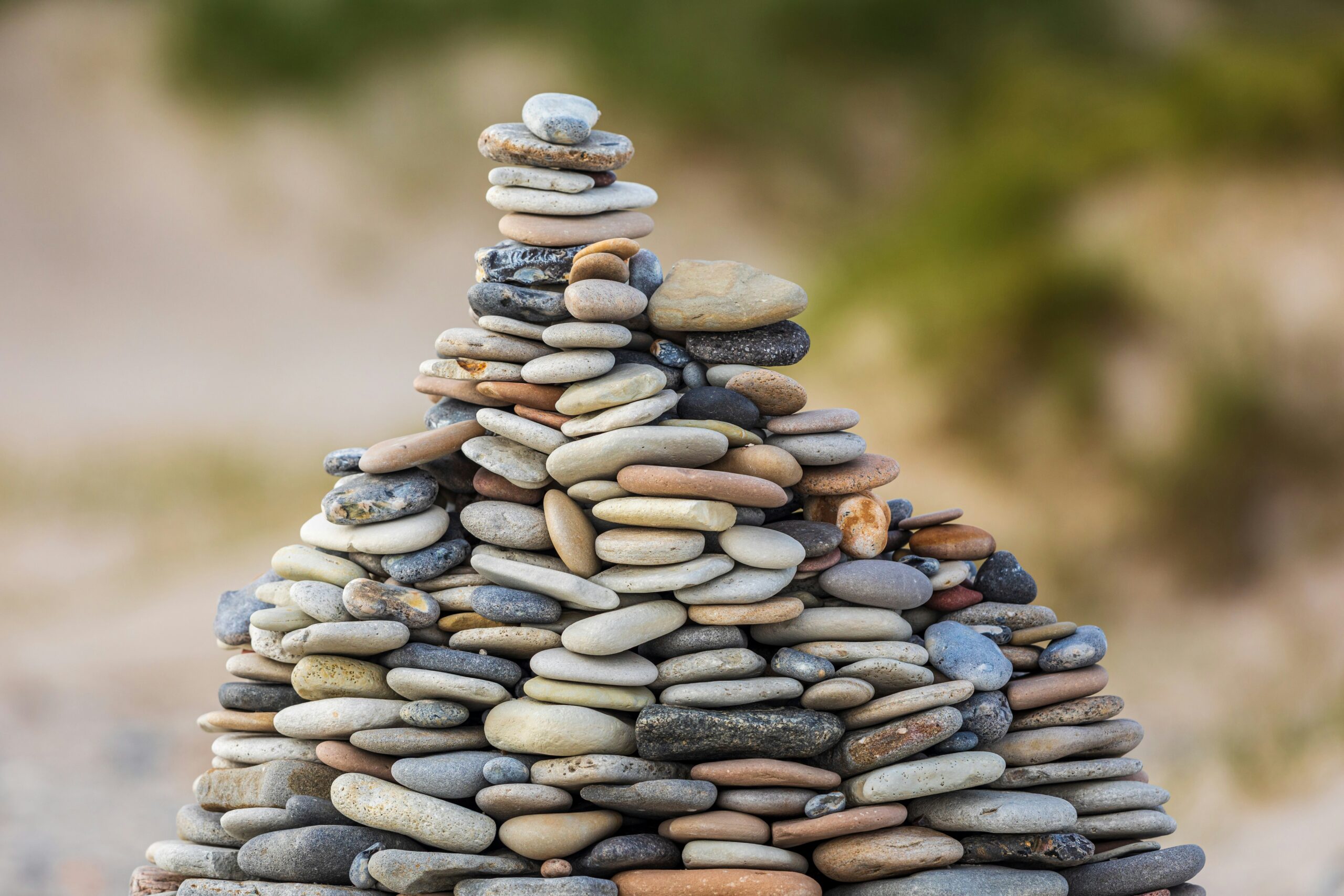 photo of stones stacked upon each other outside | EY capabilities to build customers' trust concept