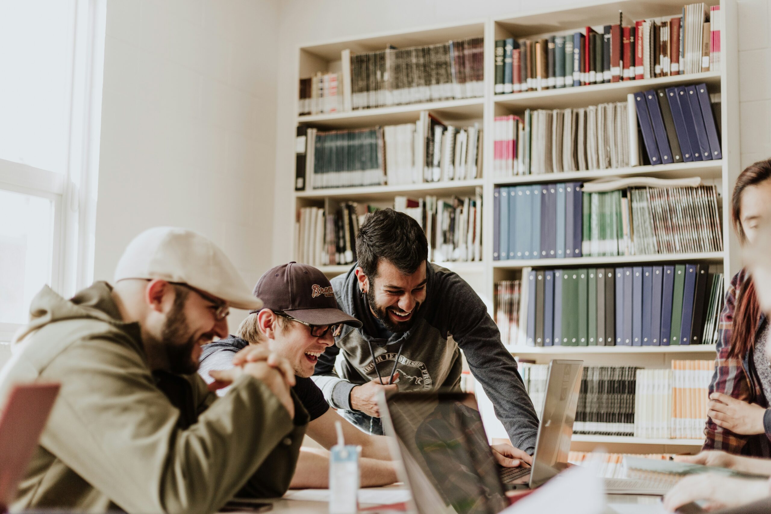 photo of a group of people in the office looking at a laptop and laughing | Google Cloud and Stagwell AI collaboration