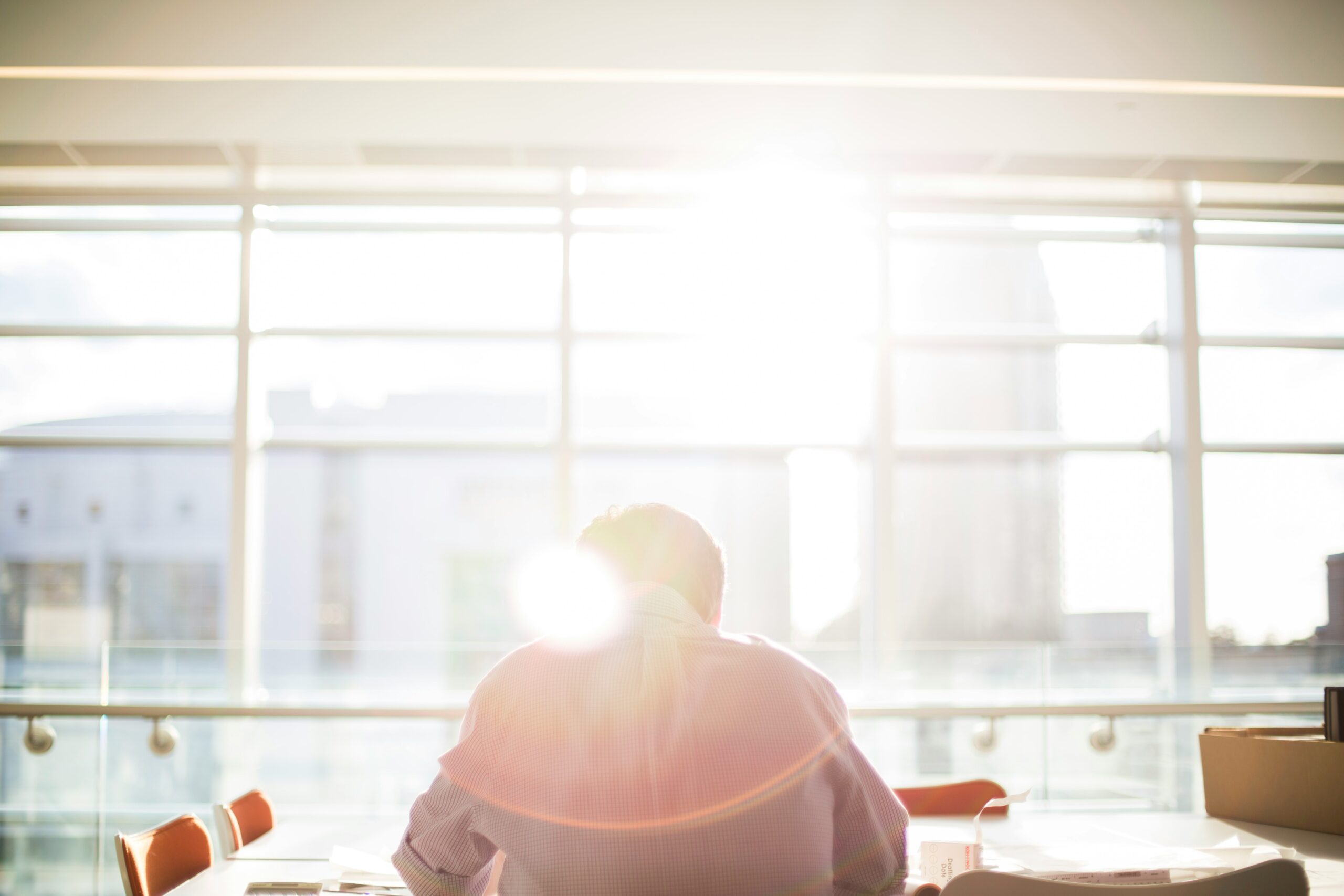 a man reading in an office filled with sunlight | automated regression testing, Original Software and CertainTeed story