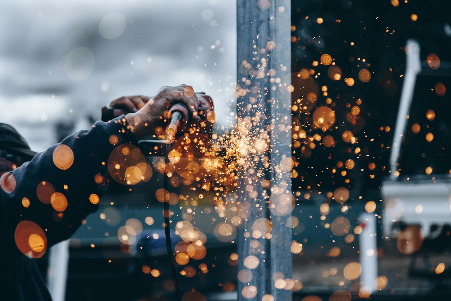 image of person holding a welder with sparks flying at the camera | manufacturers