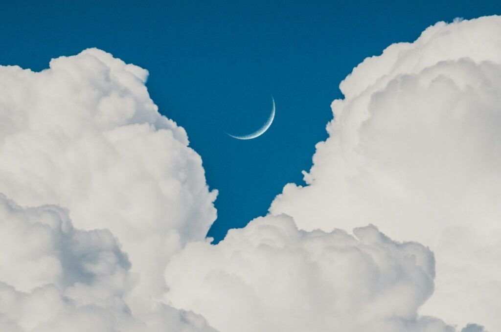 image of moon perfectly centered between the clouds | Cloud