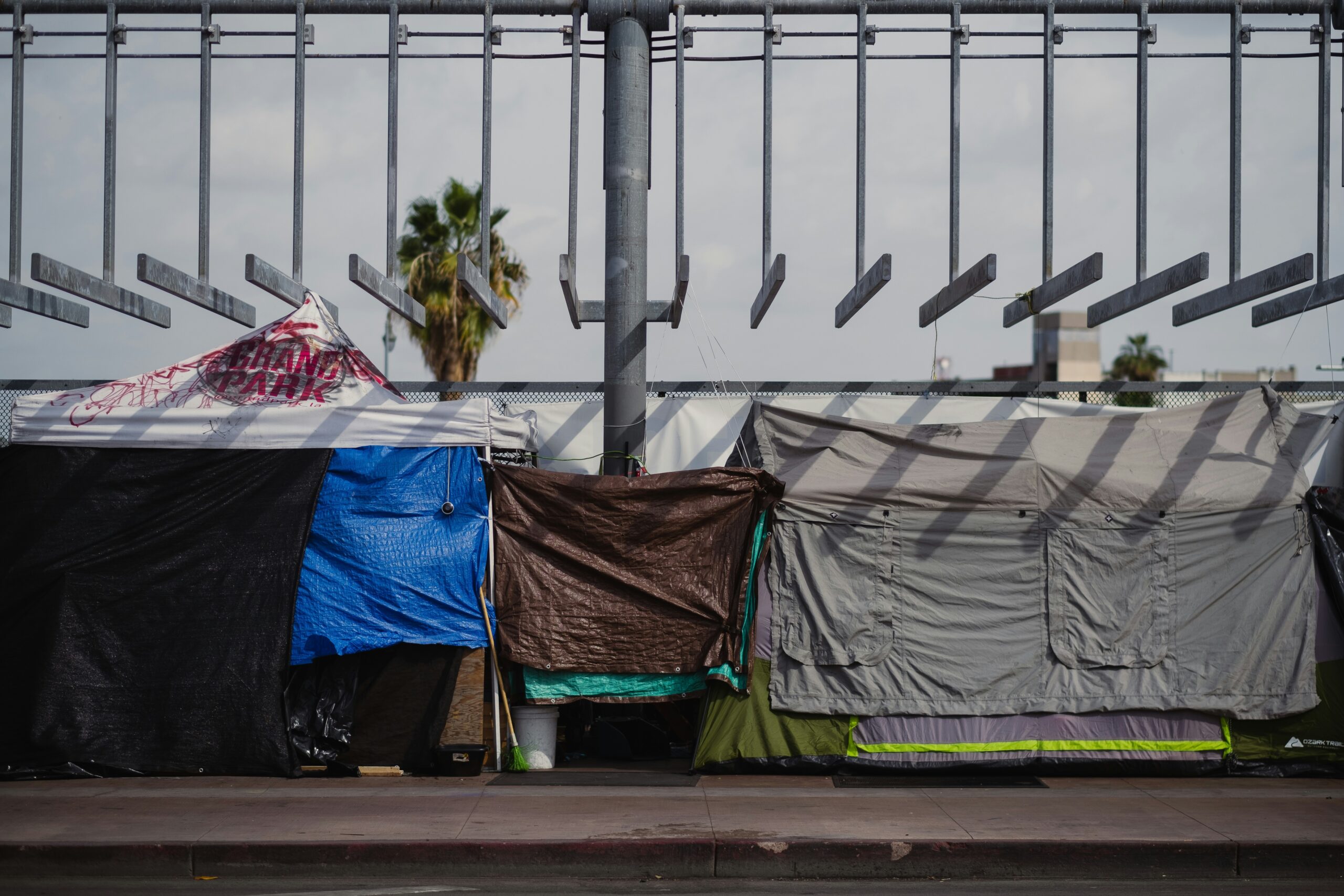 A homeless camp showing three different tents strung together | NewRocket ServiceNow