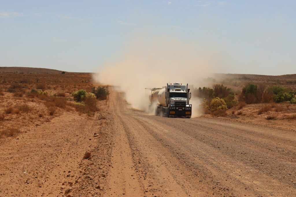 a truck driving on a desert-like road | Automation and AI duo “doing things that organizations could never do before”