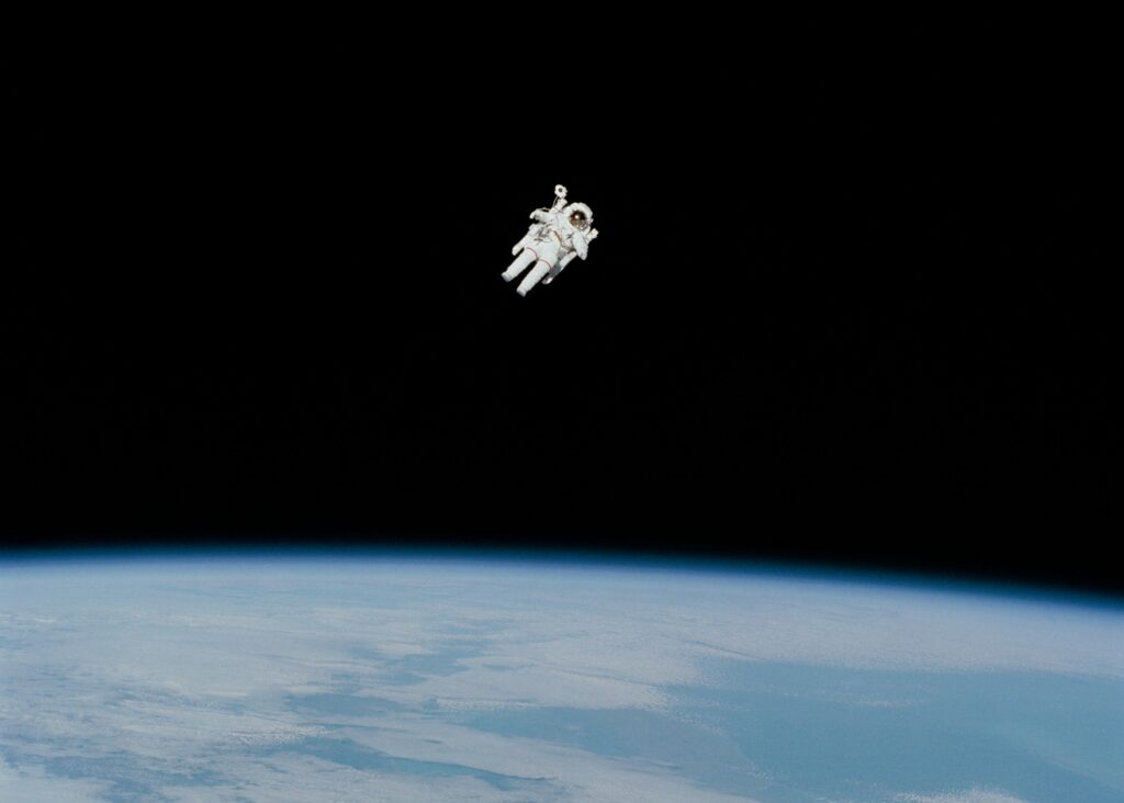 image of an astronaut floating in space above Earth | 10X ERP