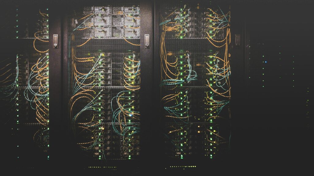 A moody image of a darkened server room with a large amount of connecting cables | Celonis S/4HANA
