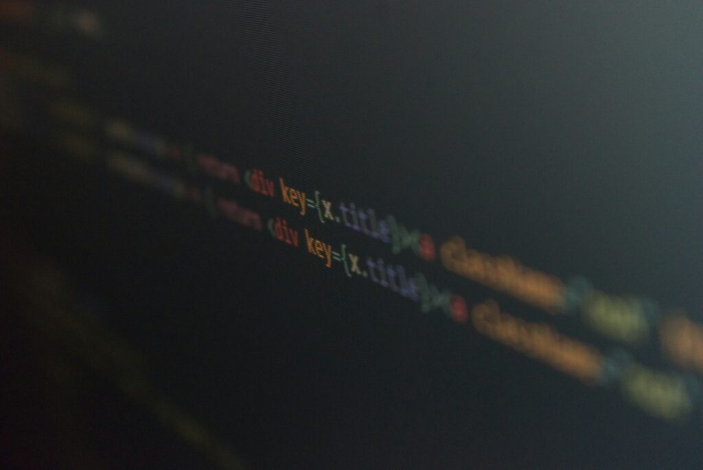 2 lines of coding that are slightly out of focus on a black screen | low-code ERP Axelor