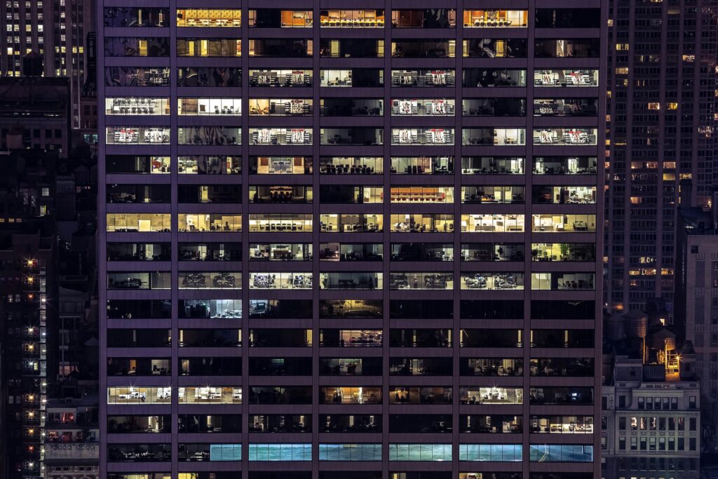 image of a building with people in every window | Sovos and PwC