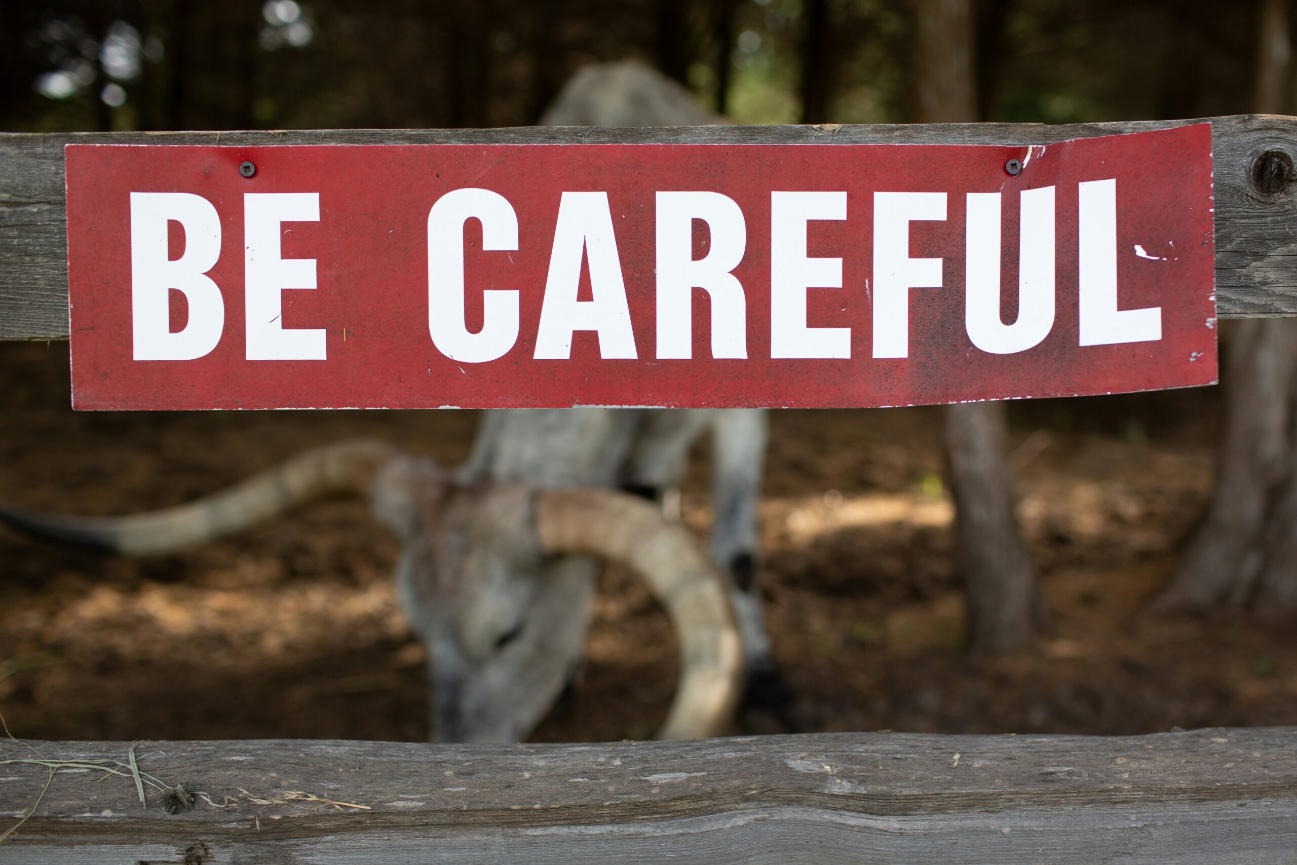 A slightly bent warning sign saying be careful | Rimini Street