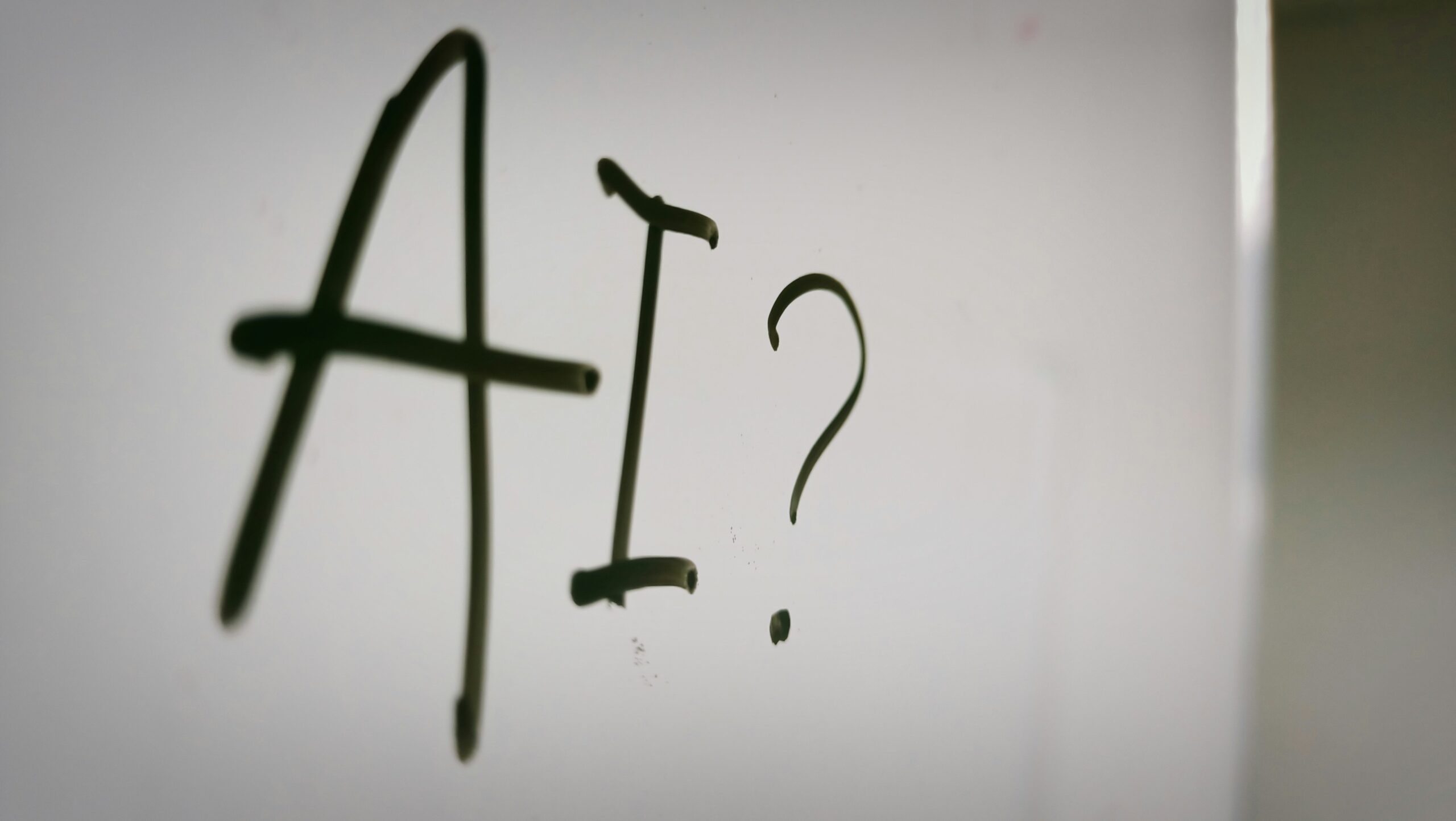 Close up image of the word AI? on a whiteboard | QAD AI