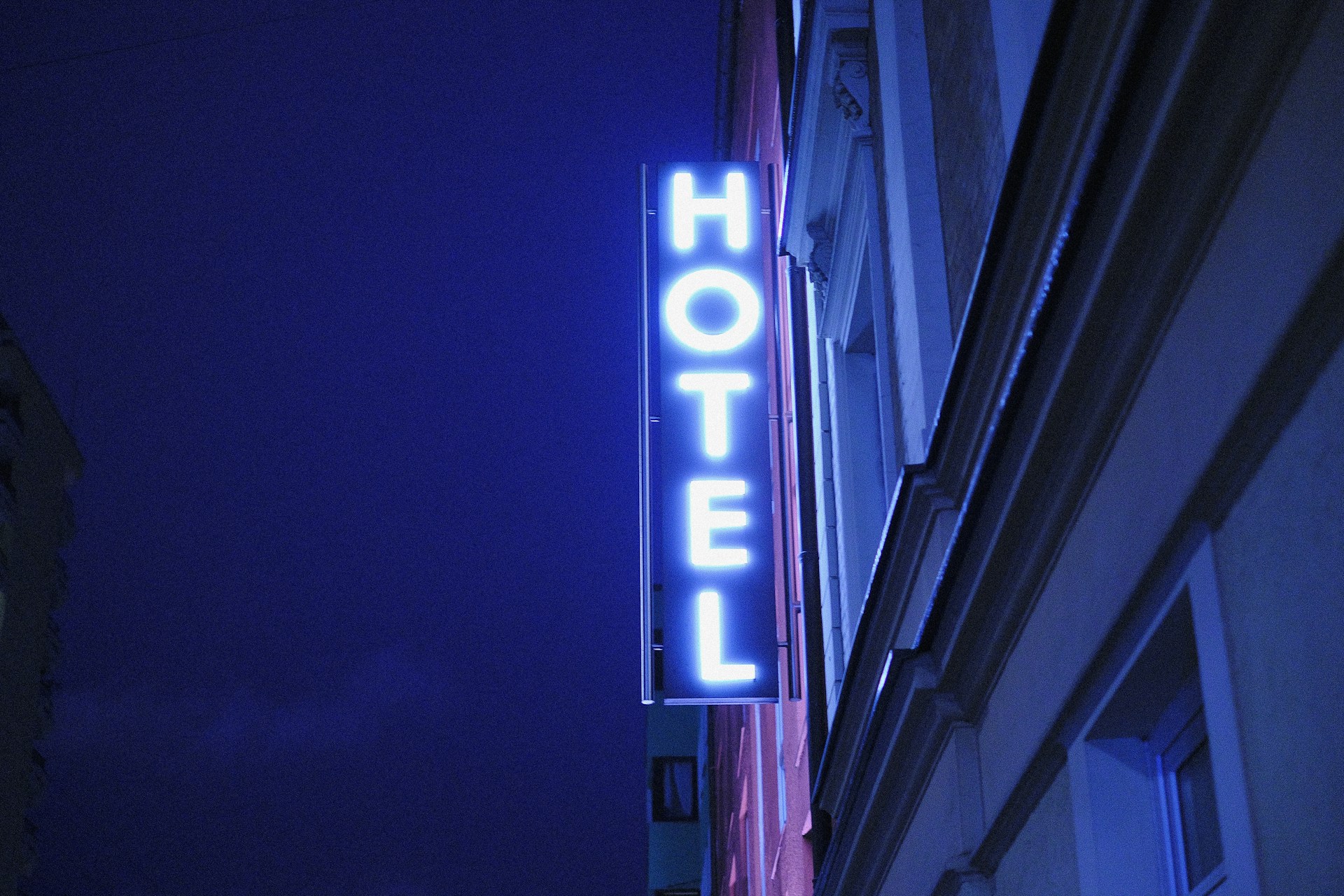 image of a hotel sign at night | ComOps