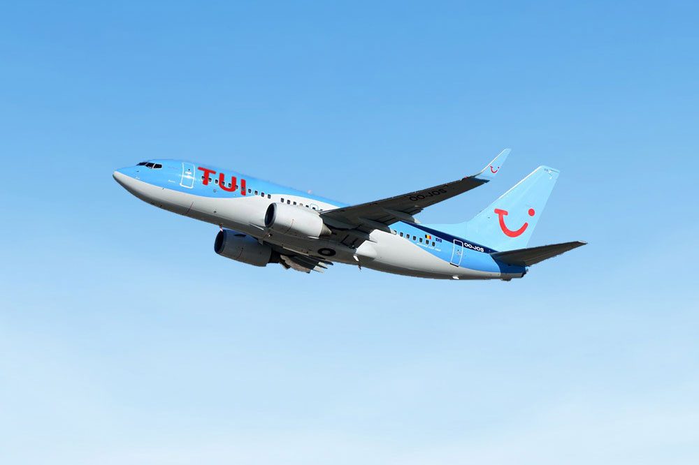 Image of an aeroplane in flight with TUI branding. | AWS